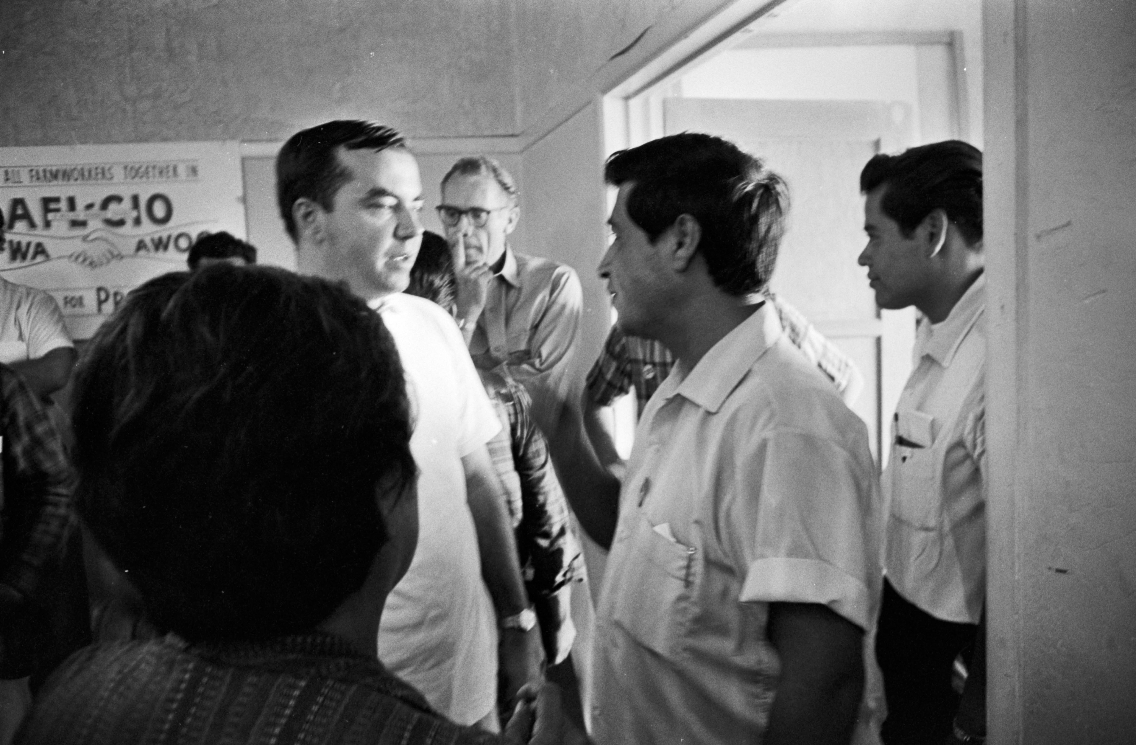 Chris Hartmire talking to César Chávez at Filipino Hall, Delano, CA, 1966