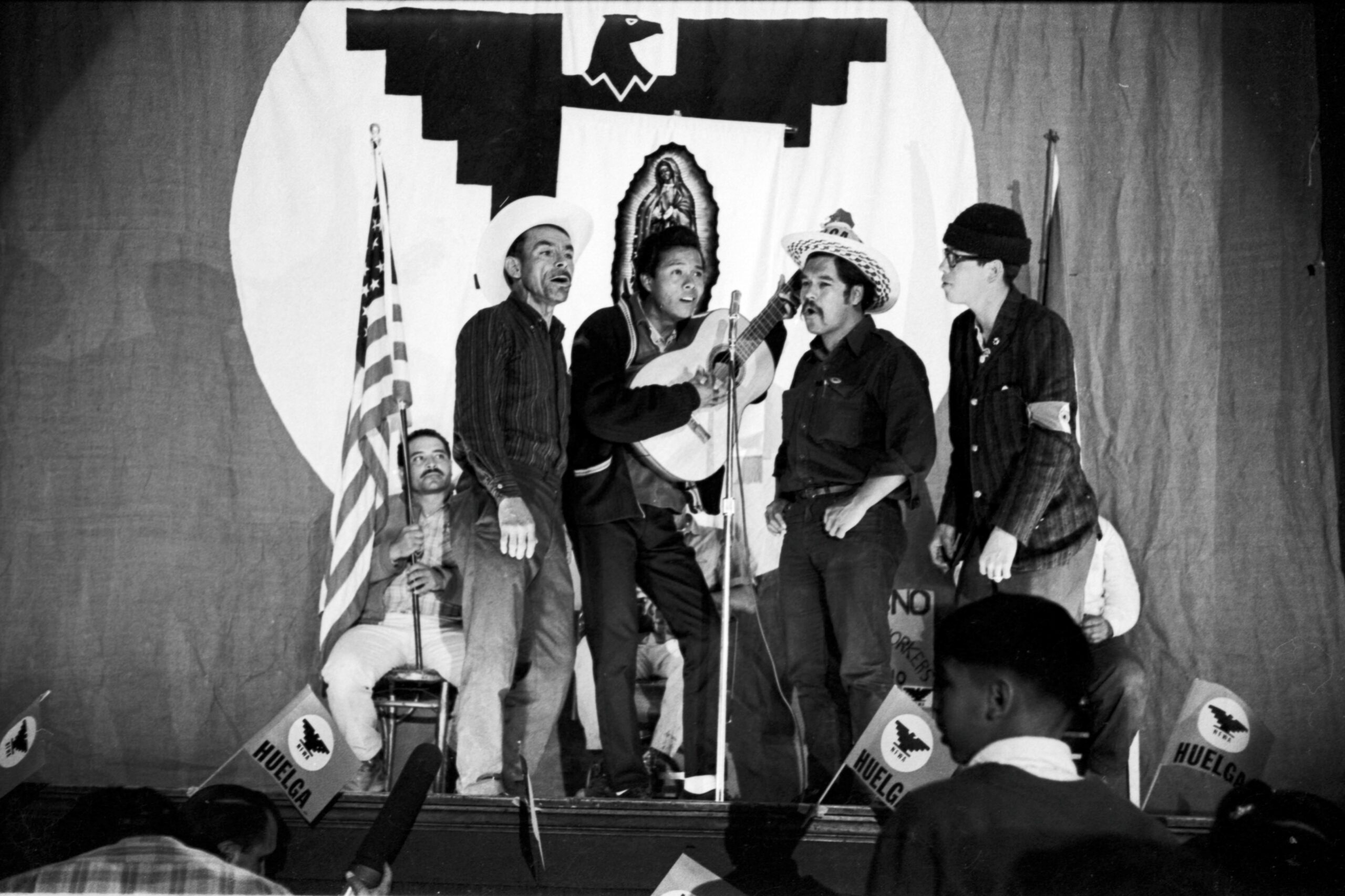 Felipe Cantú, Agustín Lira, Luis Valdez, Gilbert Rubio singing on stage at Teatro Azteca during the march to Sacramento, Fresno, 1966