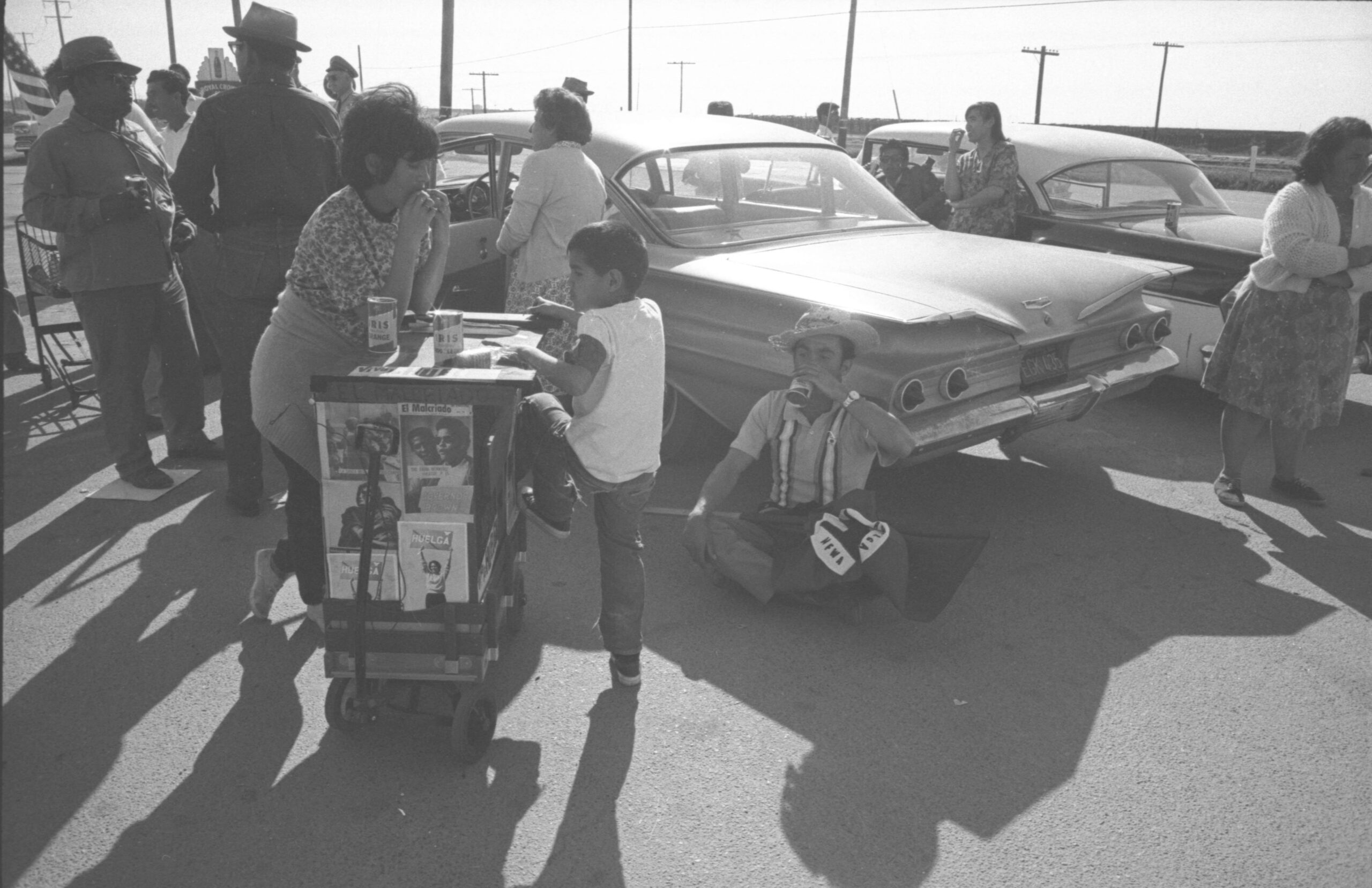 Marchers resting next to El Malcriado cart during the march to Sacramento, 1966