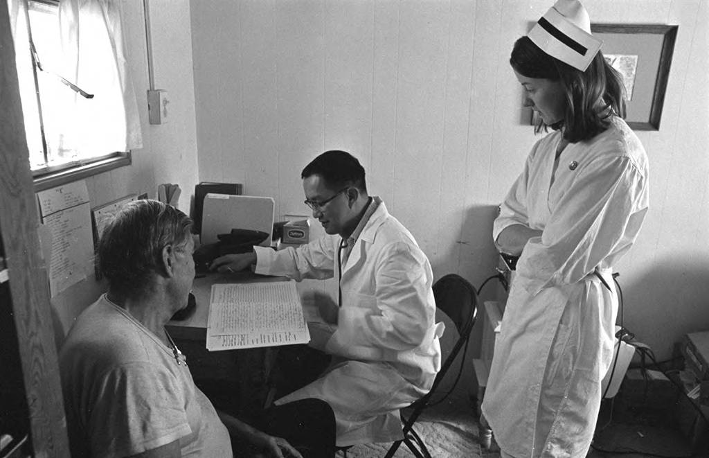 Nurse Peggy McGivern and an unidentified doctor visit a patient at the clinic.